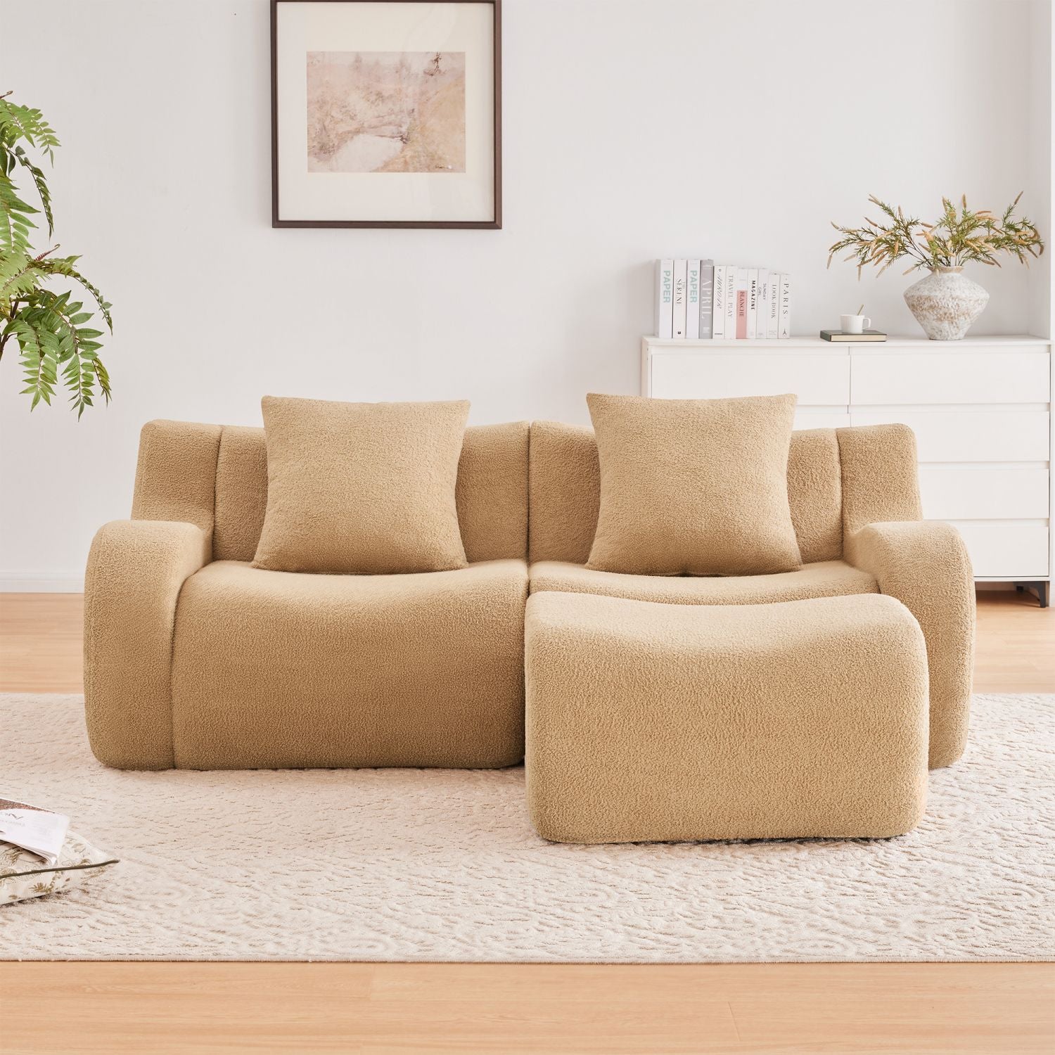 Beige sectional sofa in a living room setting with decor elements.